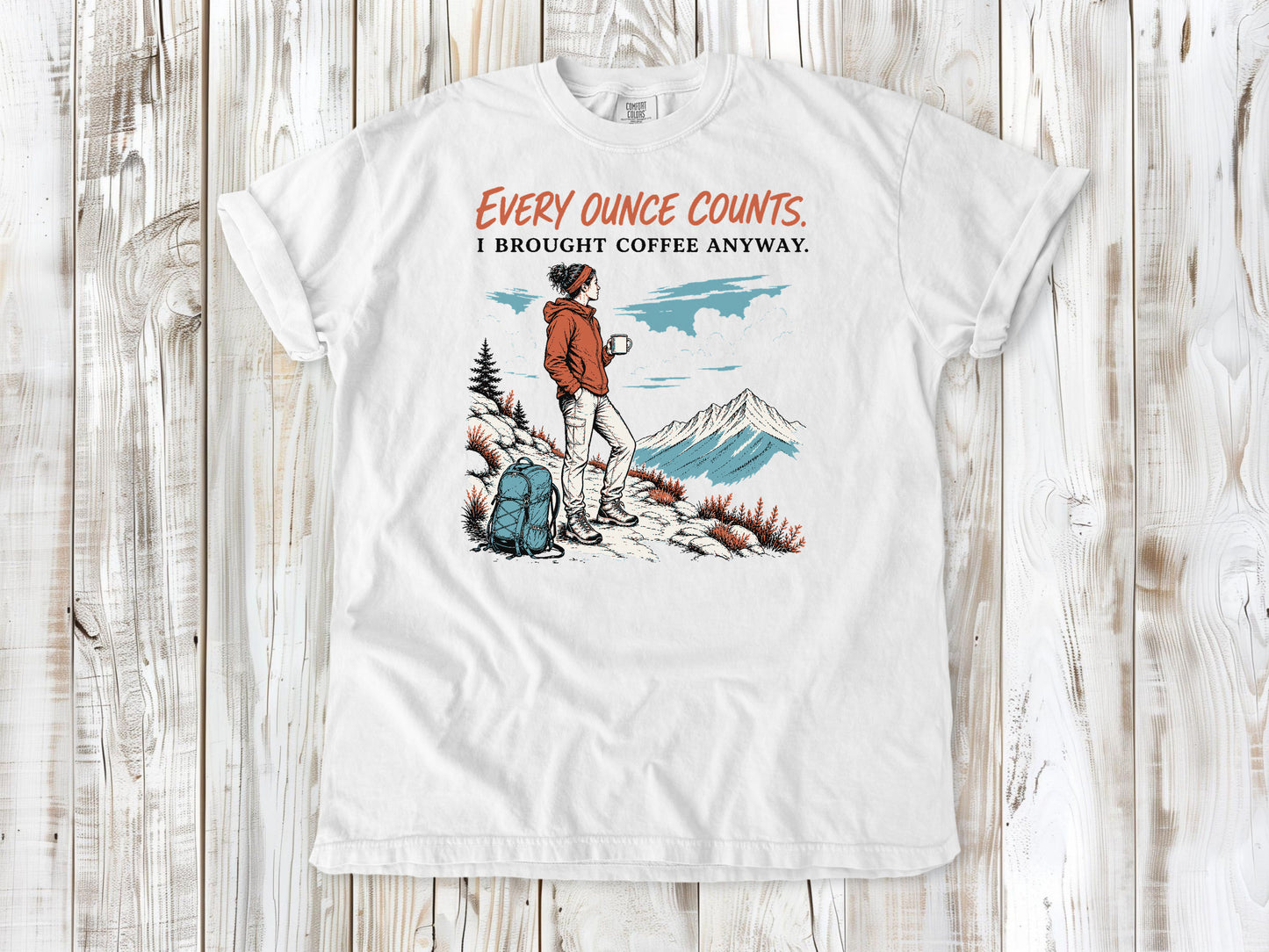 White garment-dyed tee with Every Ounce Counts I Brought Coffee Anyway backpacking graphic.