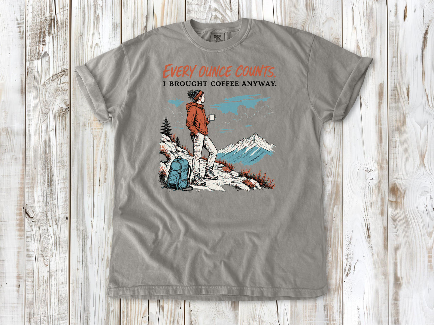 Khaki garment-dyed tee with Every Ounce Counts I Brought Coffee Anyway backpacking graphic.