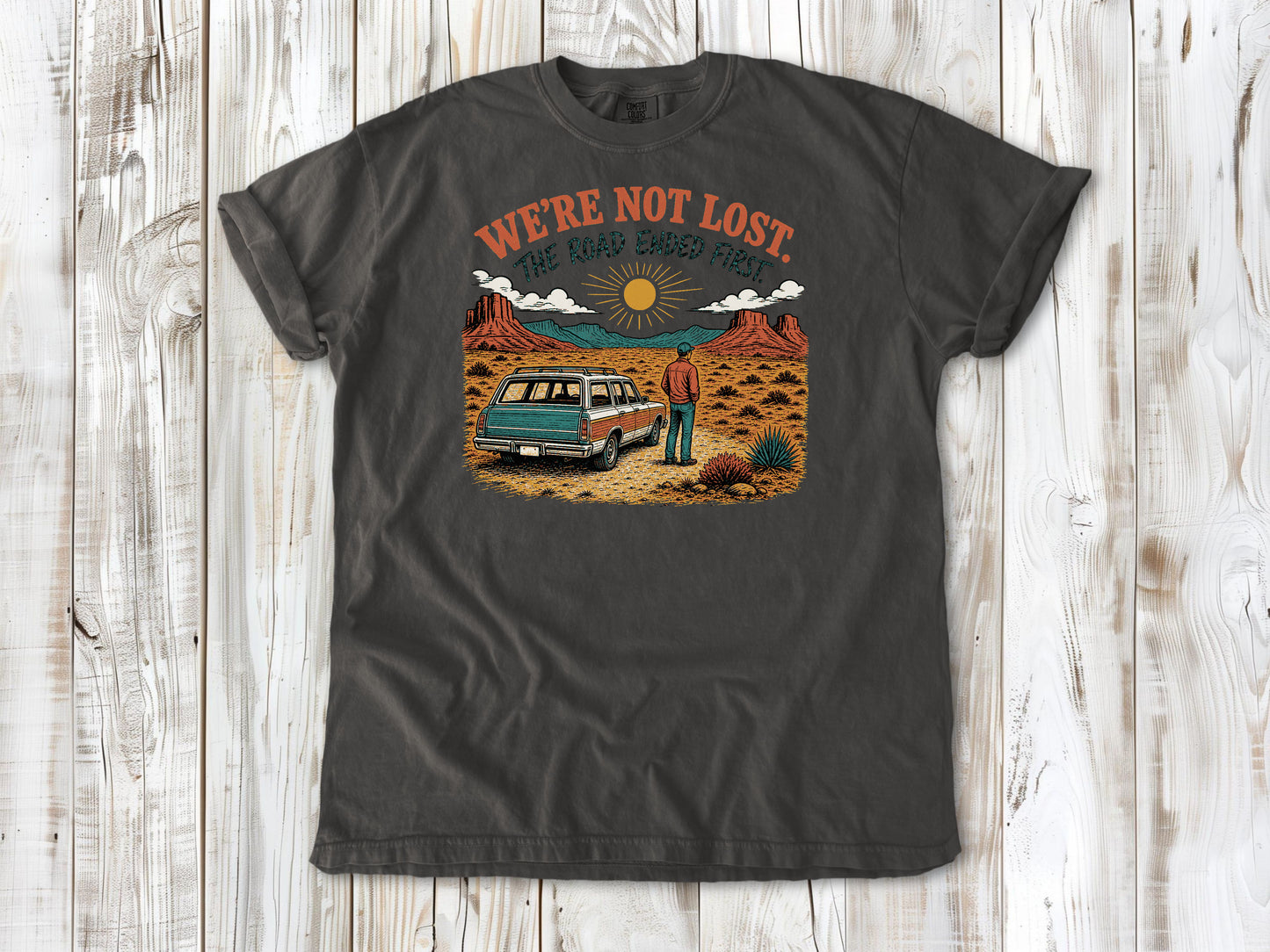 Ivory garment-dyed tee with We're Not Lost The Road Ended First off-road graphic.