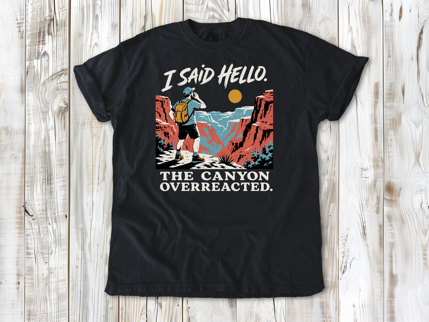 Washed Denim garment-dyed tee with I Said Hello The Canyon Overreacted hiking graphic.