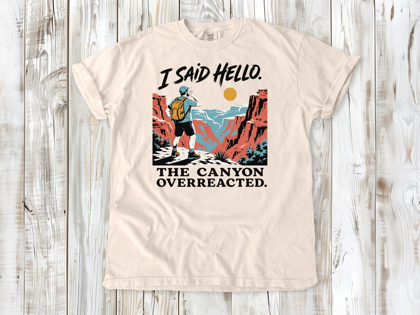 Butter garment-dyed tee with I Said Hello The Canyon Overreacted hiking graphic.