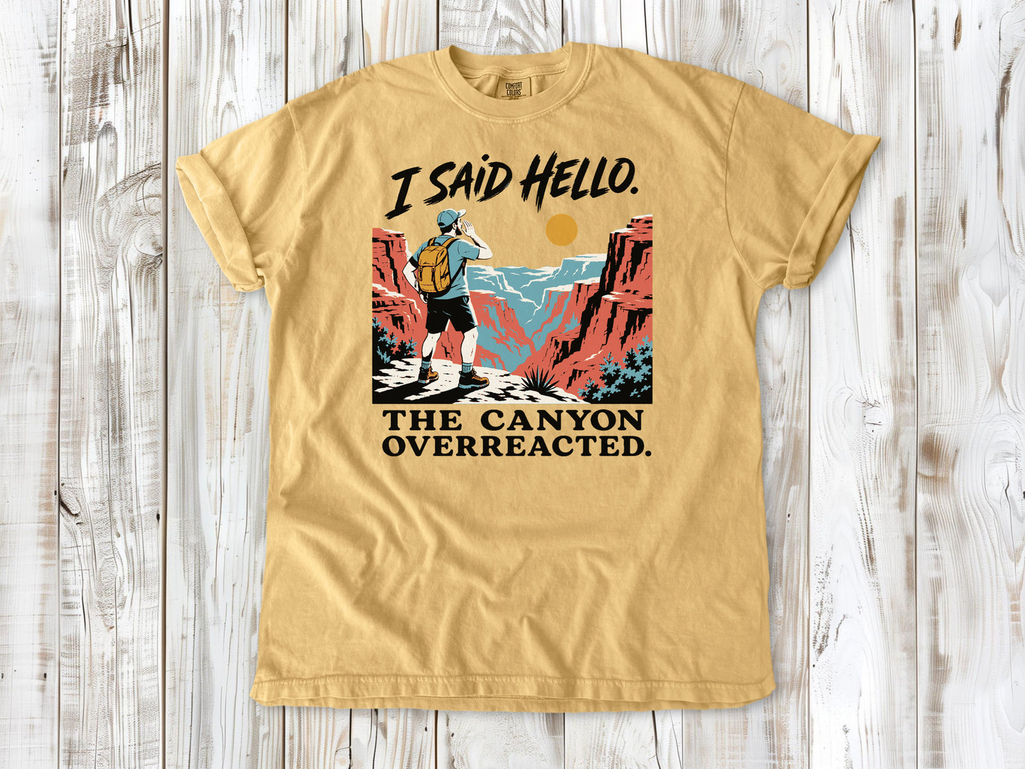 Burnt Orange garment-dyed tee with I Said Hello The Canyon Overreacted hiking graphic.