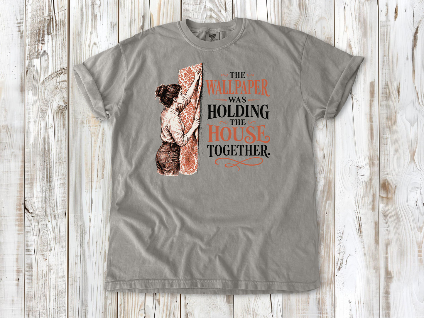 Khaki garment-dyed tee with The Wallpaper Was Holding the House Together renovation graphic.