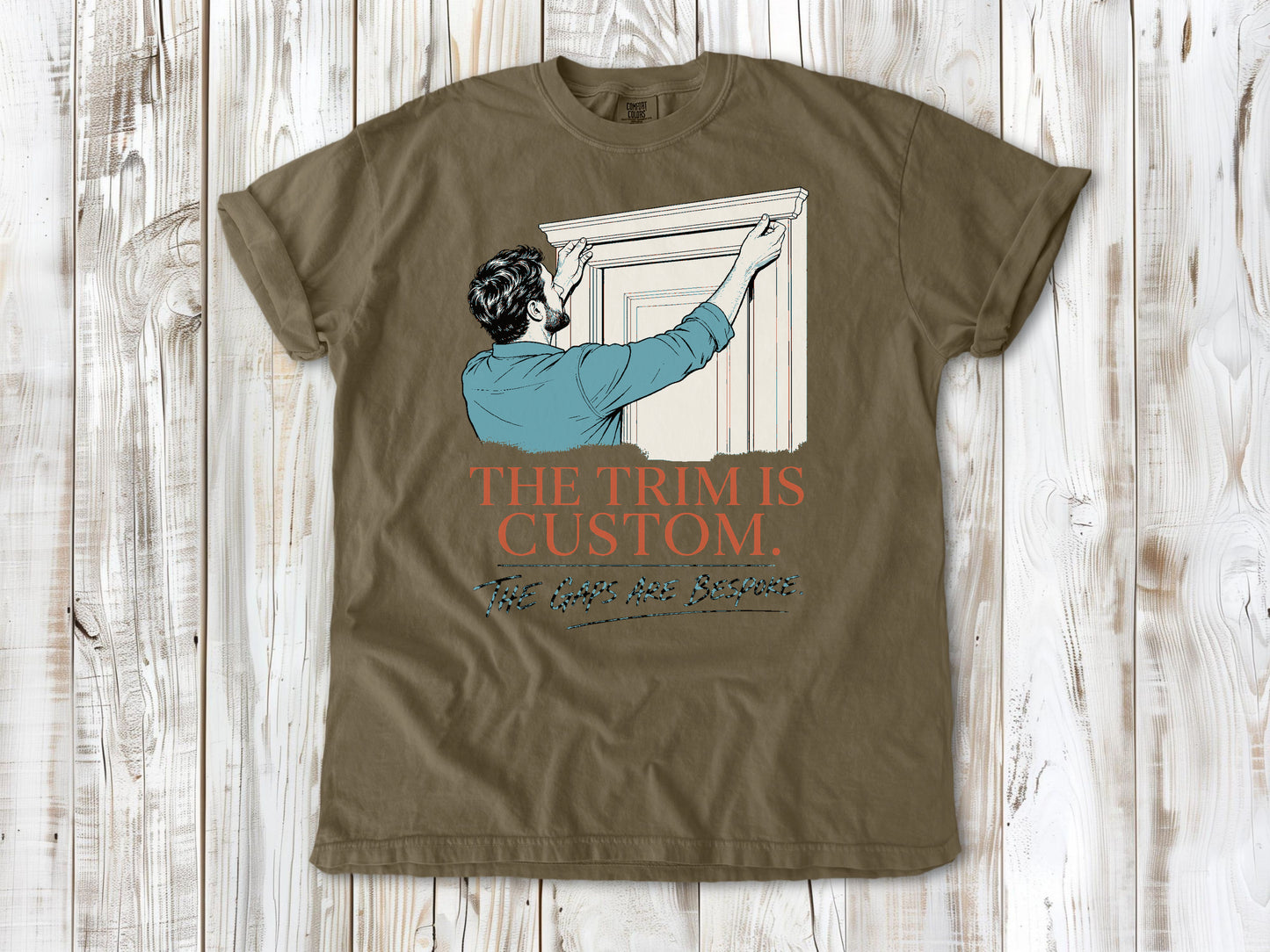 Graphite garment-dyed tee with The Trim Is Custom The Gaps Are Bespoke finish carpentry graphic.