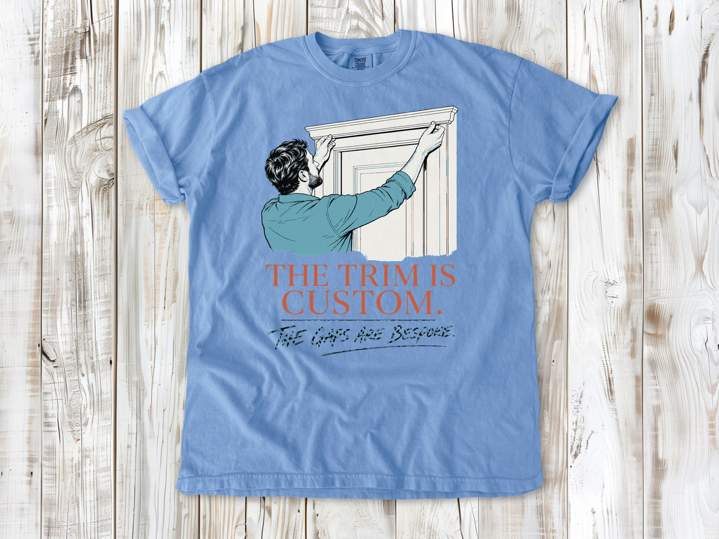 Pepper garment-dyed tee with The Trim Is Custom The Gaps Are Bespoke finish carpentry graphic.