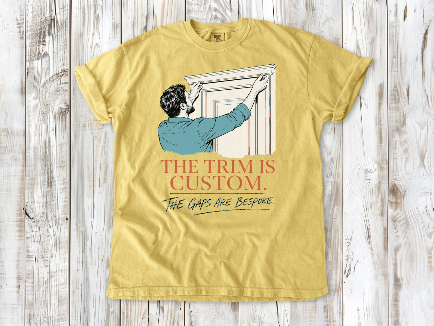 Grey garment-dyed tee with The Trim Is Custom The Gaps Are Bespoke finish carpentry graphic.