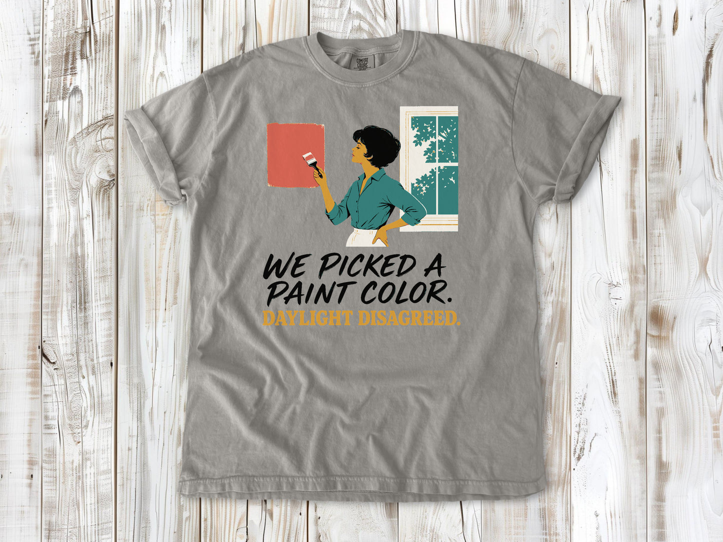 Khaki garment-dyed tee with We Picked a Paint Color Daylight Disagreed painting graphic.