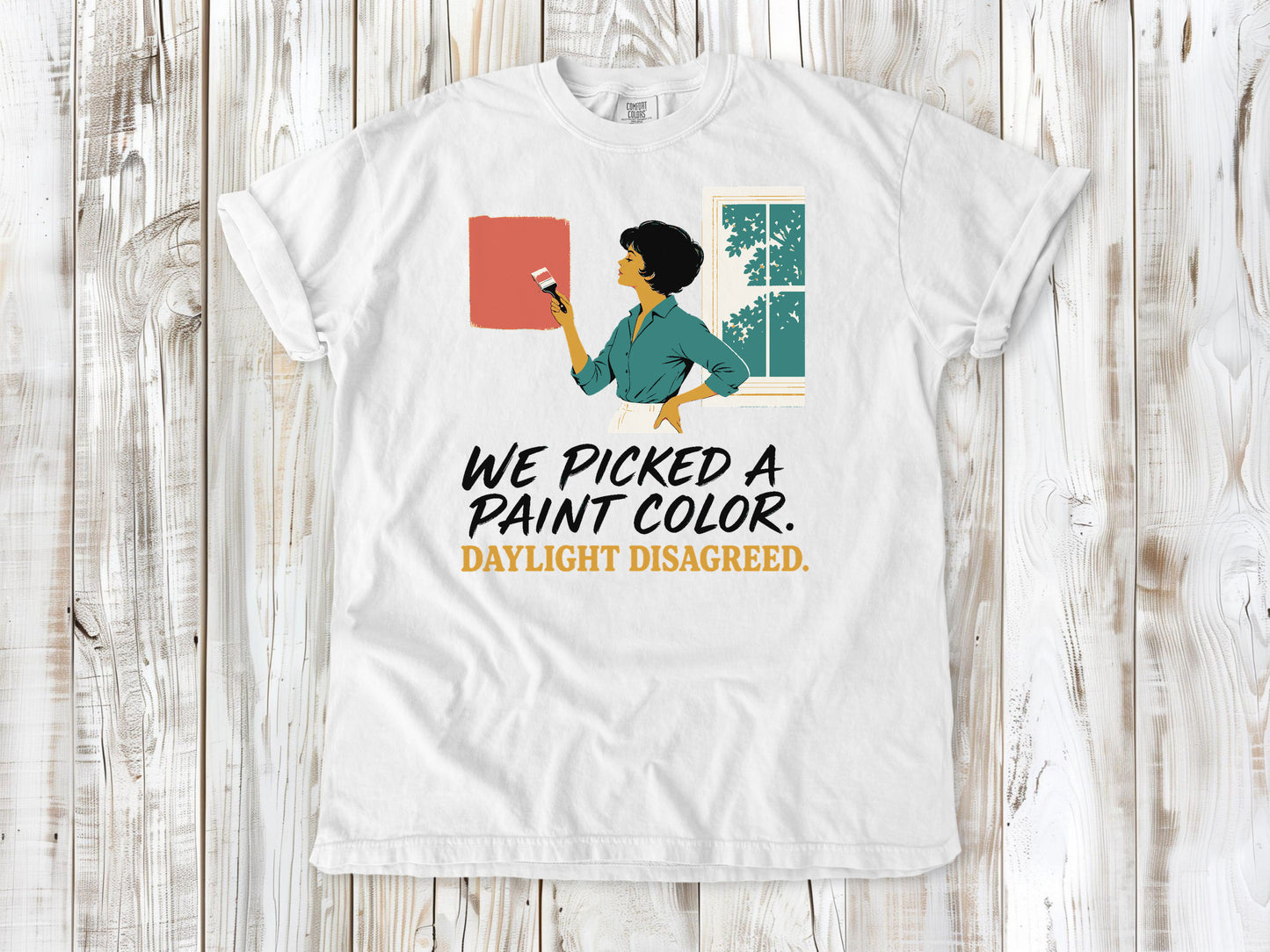 White garment-dyed tee with We Picked a Paint Color Daylight Disagreed painting graphic.