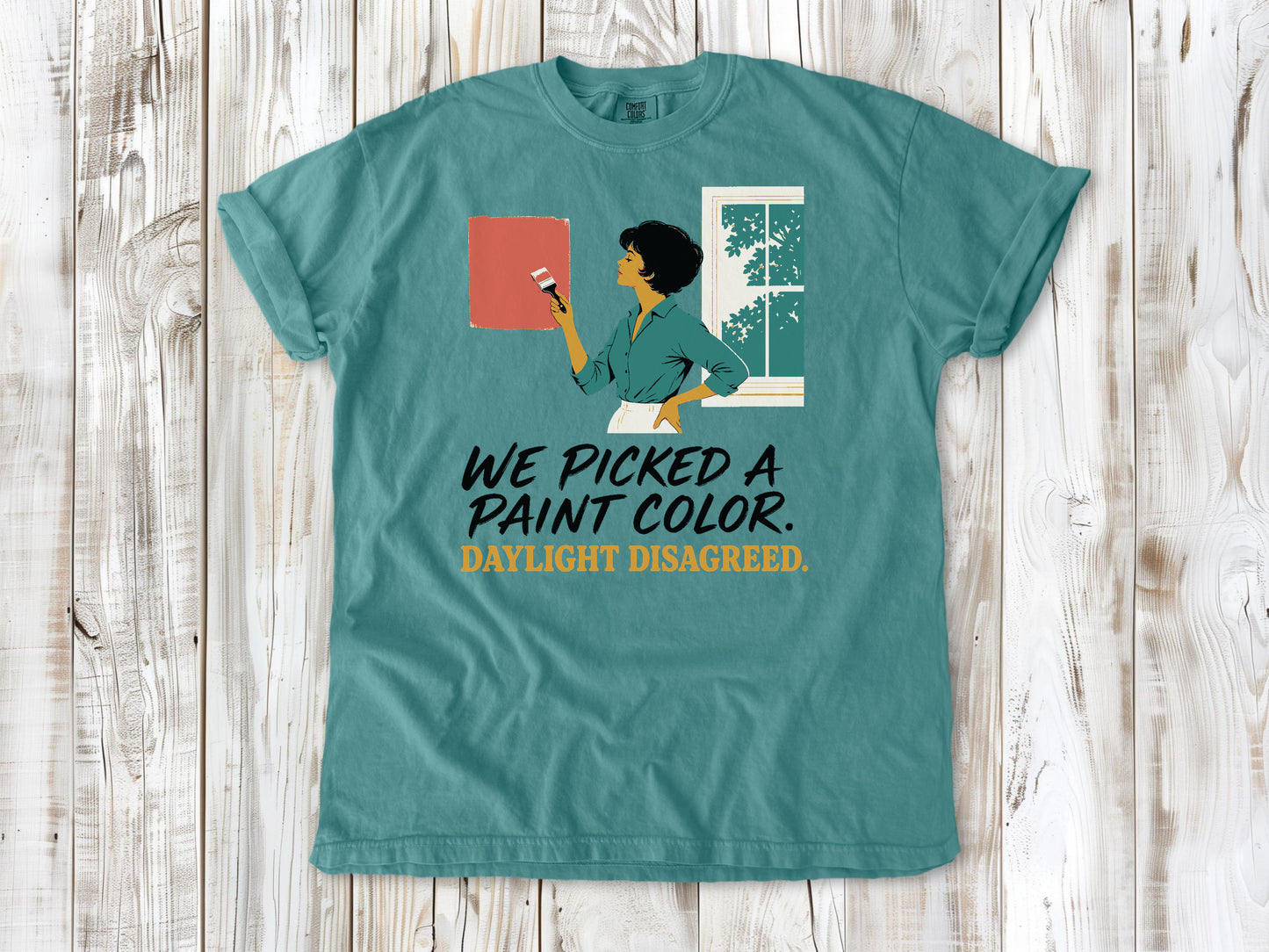 Mustard garment-dyed tee with We Picked a Paint Color Daylight Disagreed painting graphic.