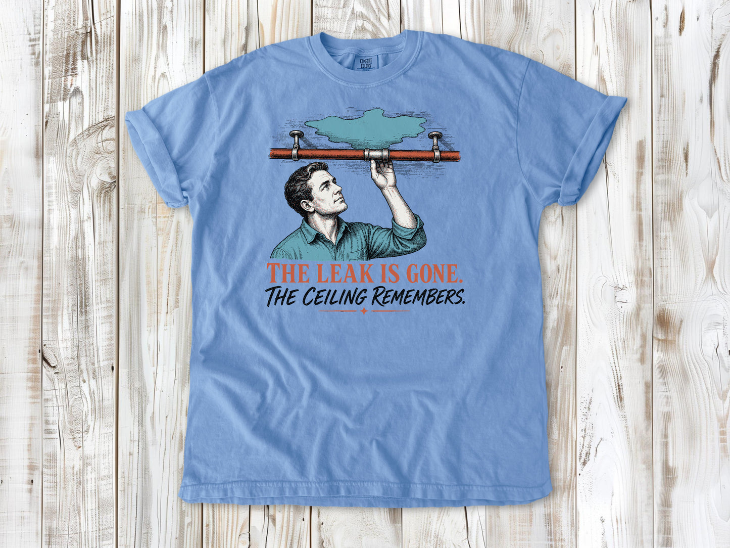 Pepper garment-dyed tee with The Leak Is Gone The Ceiling Remembers home repair graphic.