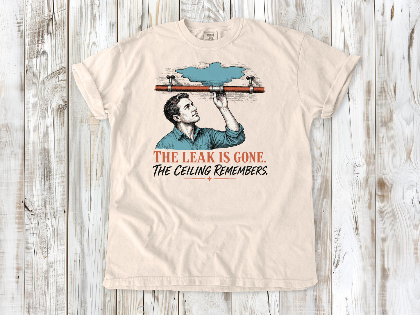 Butter garment-dyed tee with The Leak Is Gone The Ceiling Remembers home repair graphic.
