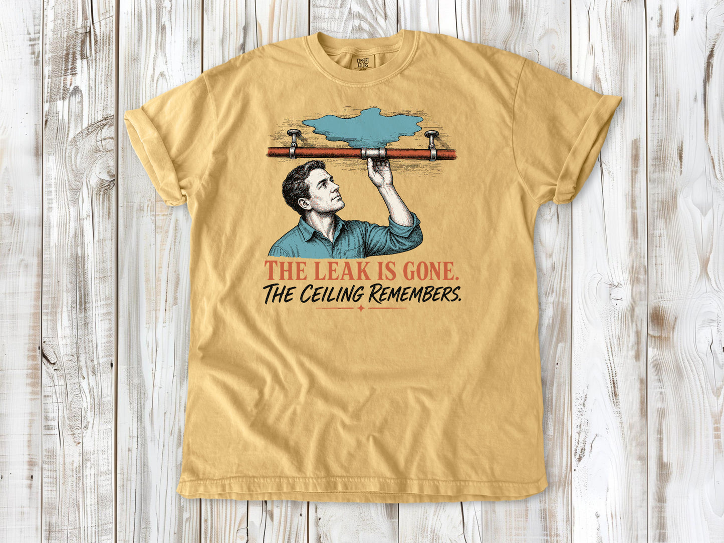 Burnt Orange garment-dyed tee with The Leak Is Gone The Ceiling Remembers home repair graphic.