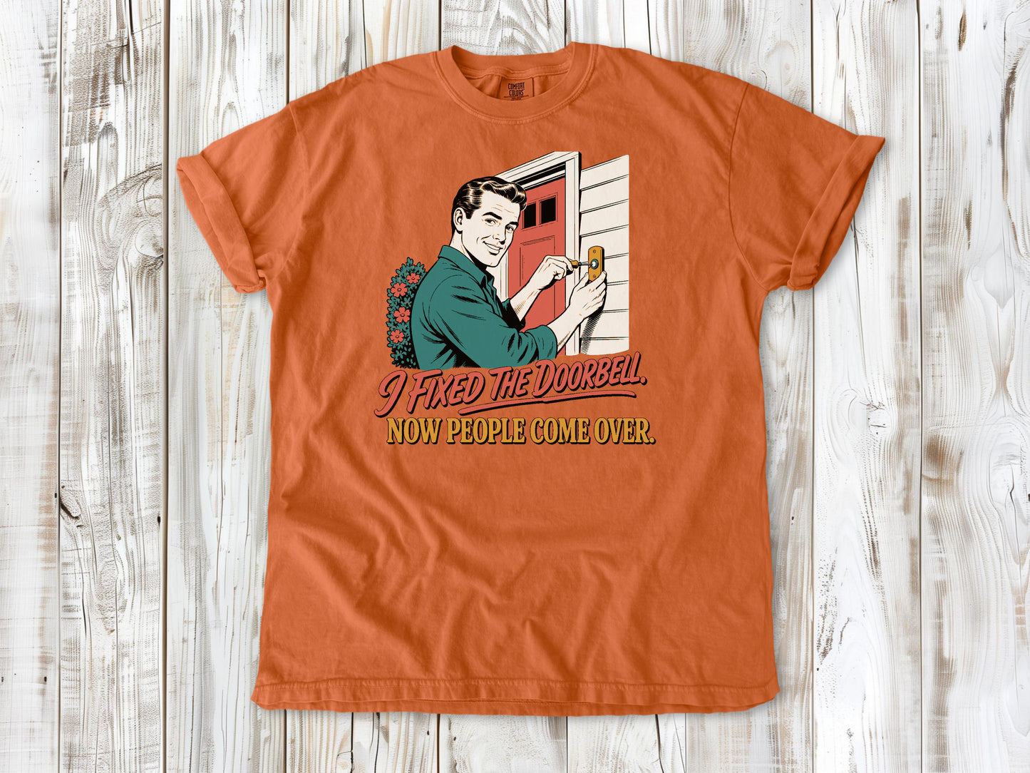 Seafoam garment-dyed tee with I Fixed the Doorbell Now People Come Over DIY graphic.