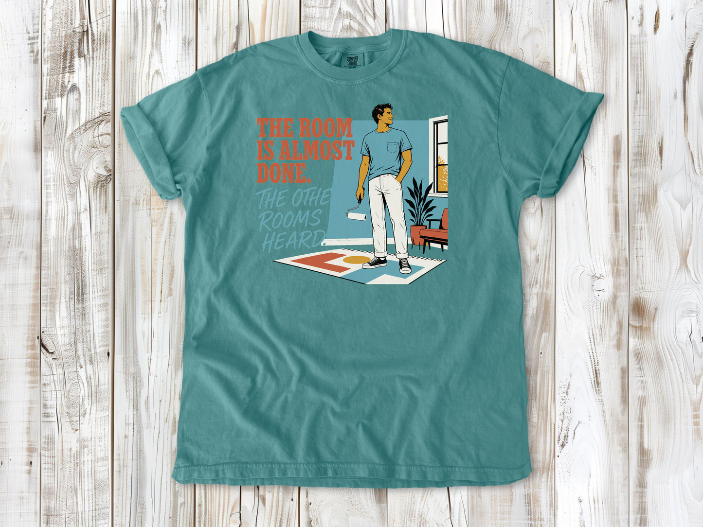Mustard garment-dyed tee with The Room Is Almost Done The Other Rooms Heard renovation graphic.