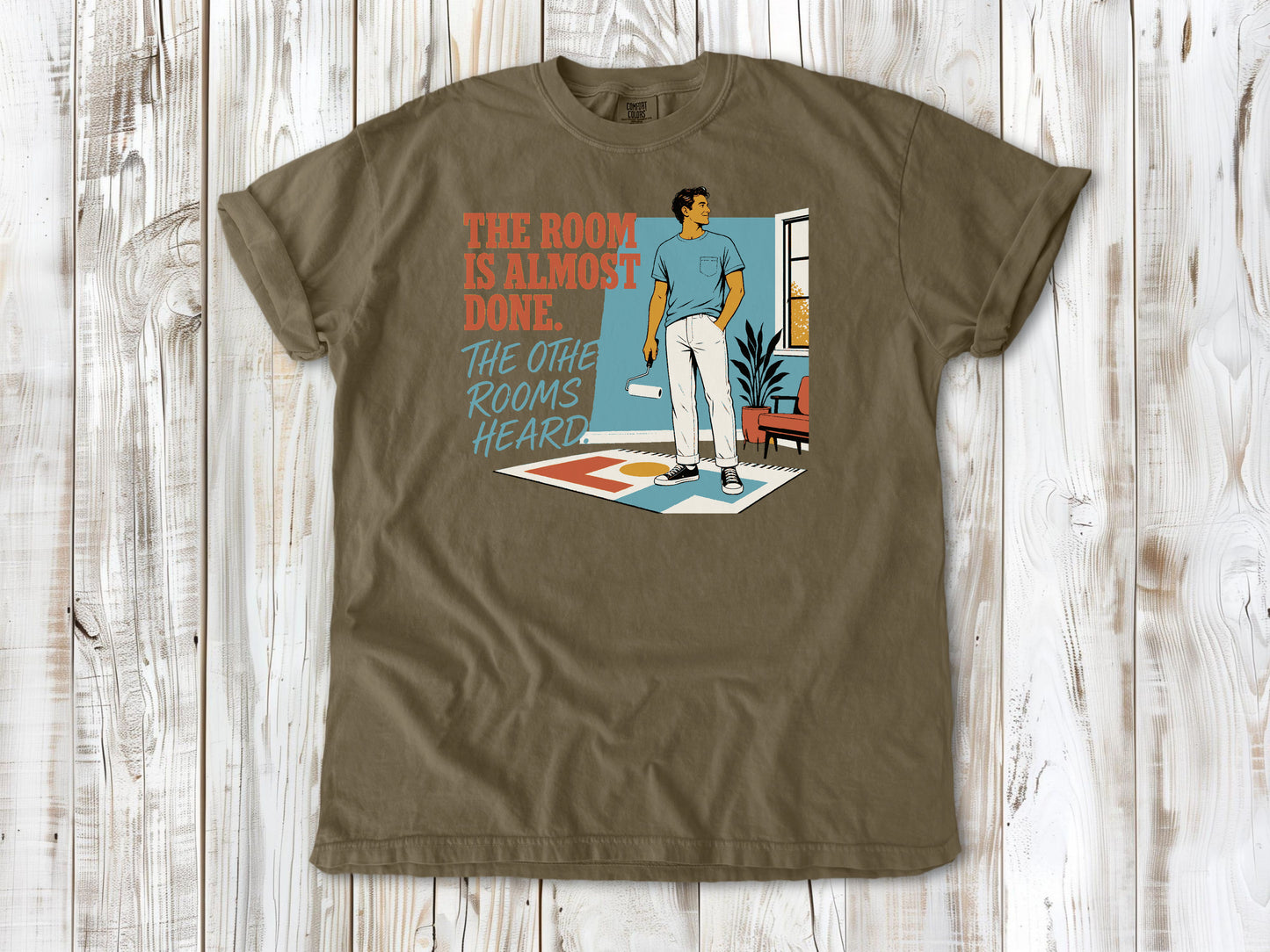 Graphite garment-dyed tee with The Room Is Almost Done The Other Rooms Heard renovation graphic.