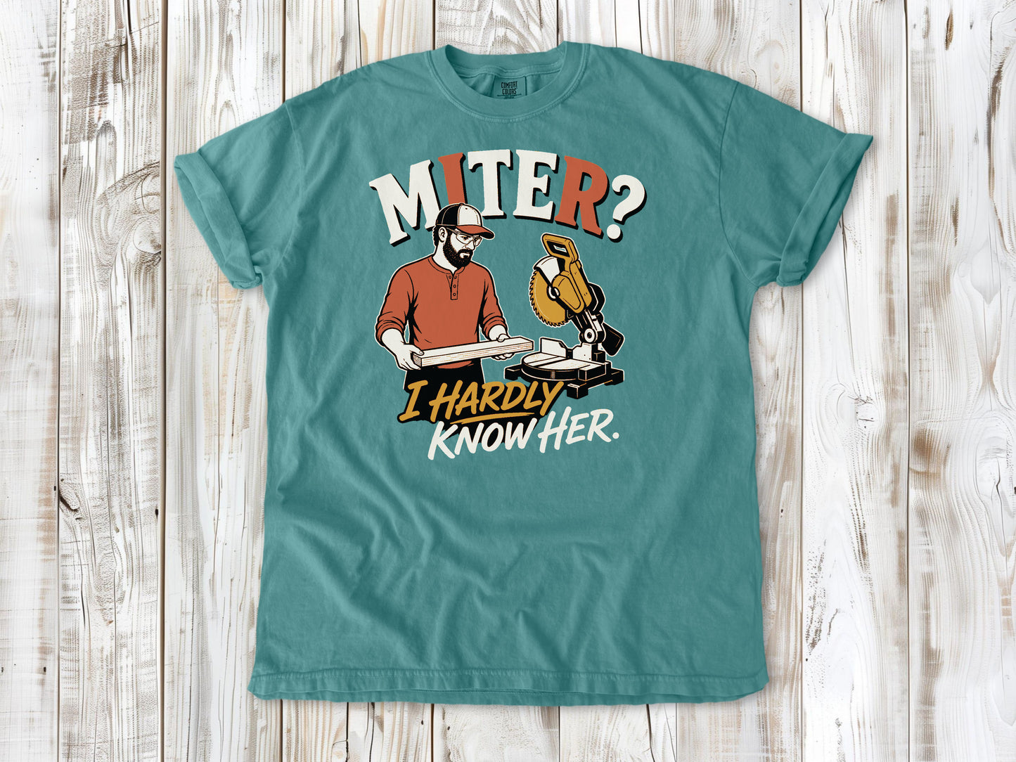 Mustard garment-dyed tee with Miter I Hardly Know Her woodworking graphic.