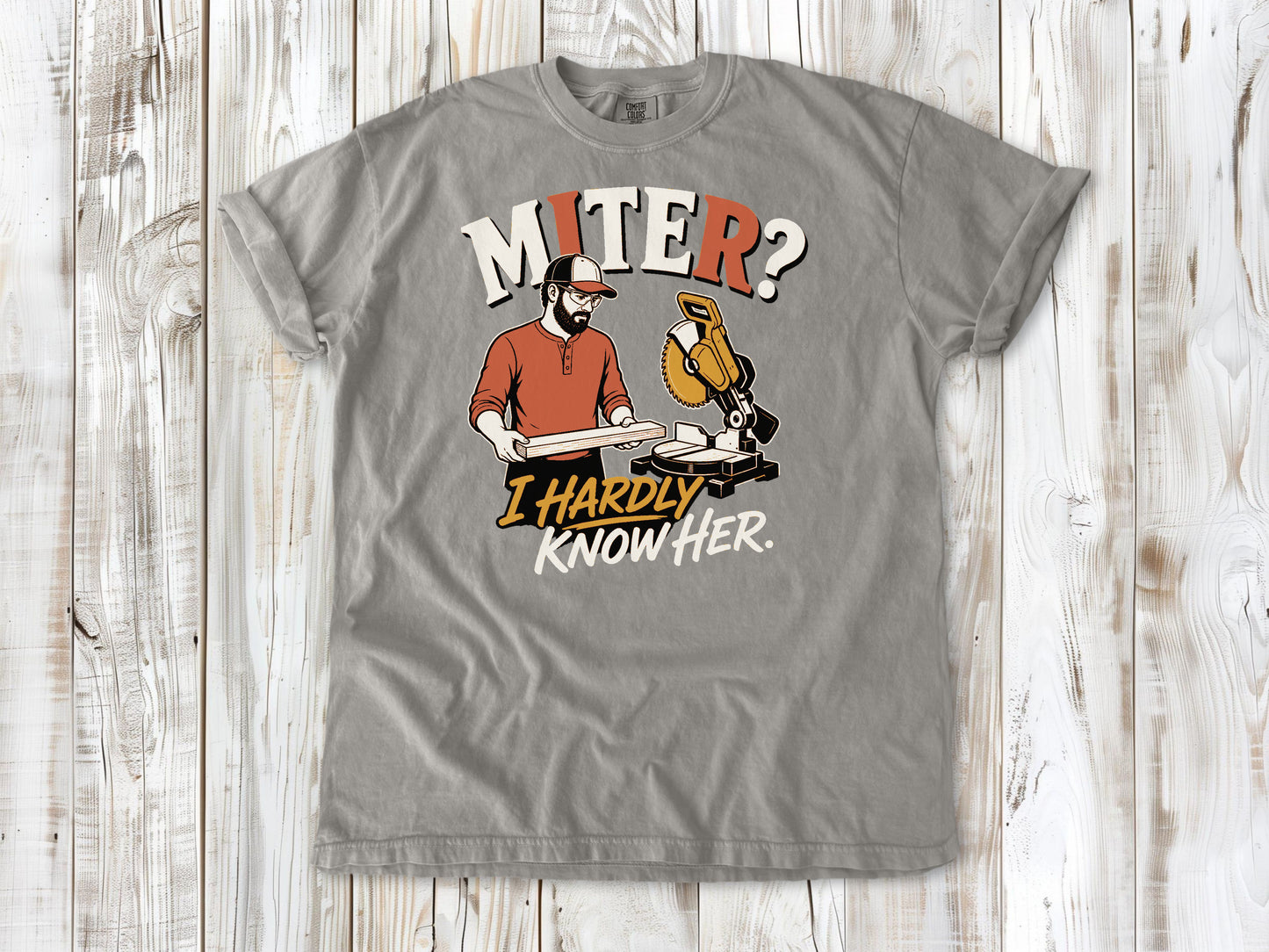 Khaki garment-dyed tee with Miter I Hardly Know Her woodworking graphic.