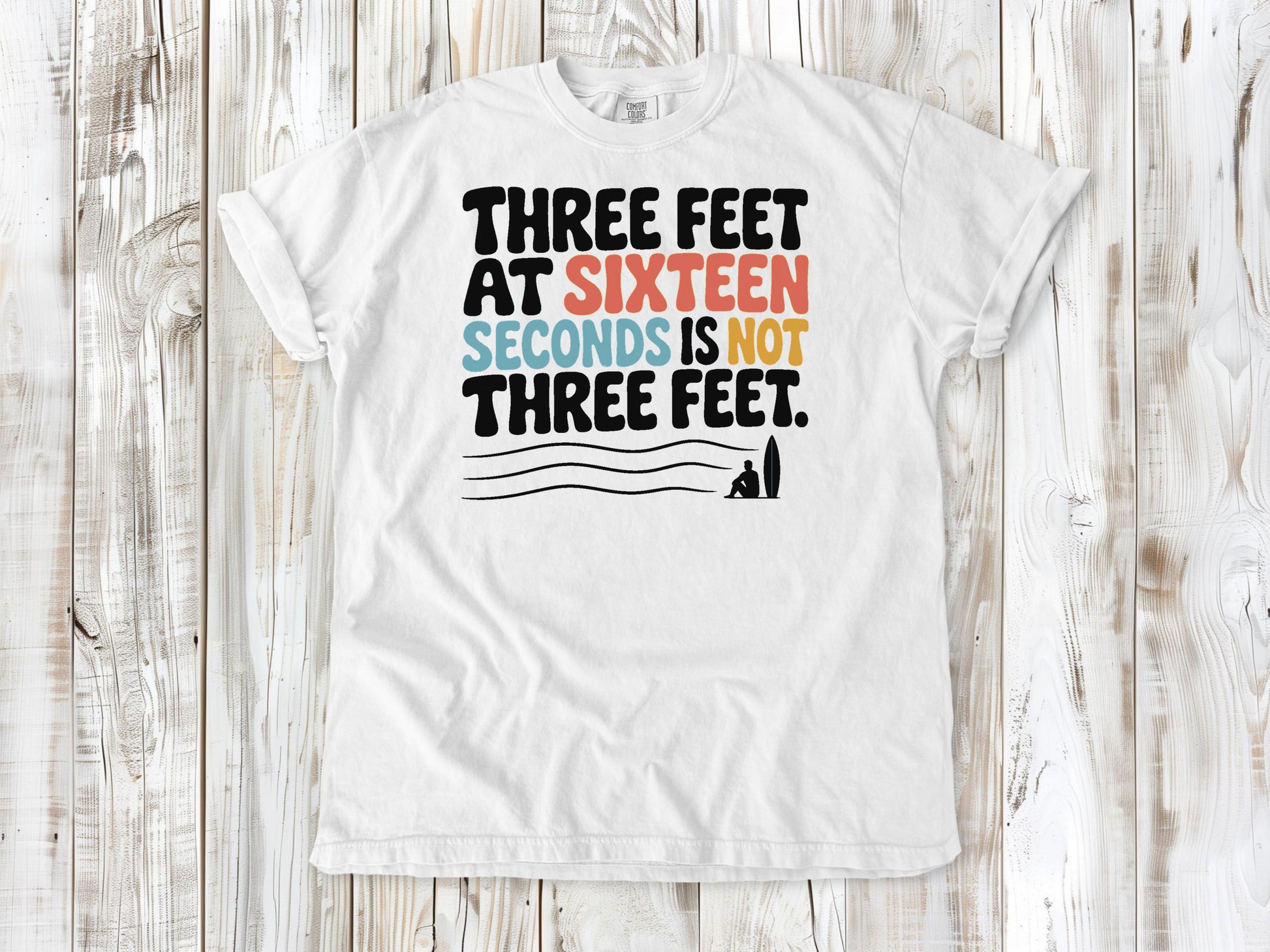 White garment-dyed tee with Three Feet at Sixteen Seconds Is Not Three Feet surf forecast graphic.