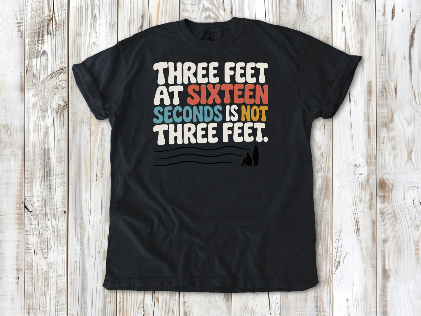Washed Denim garment-dyed tee with Three Feet at Sixteen Seconds Is Not Three Feet surf forecast graphic.