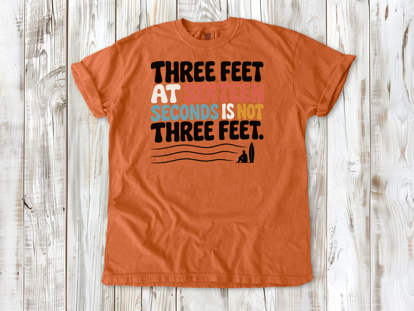 Seafoam garment-dyed tee with Three Feet at Sixteen Seconds Is Not Three Feet surf forecast graphic.