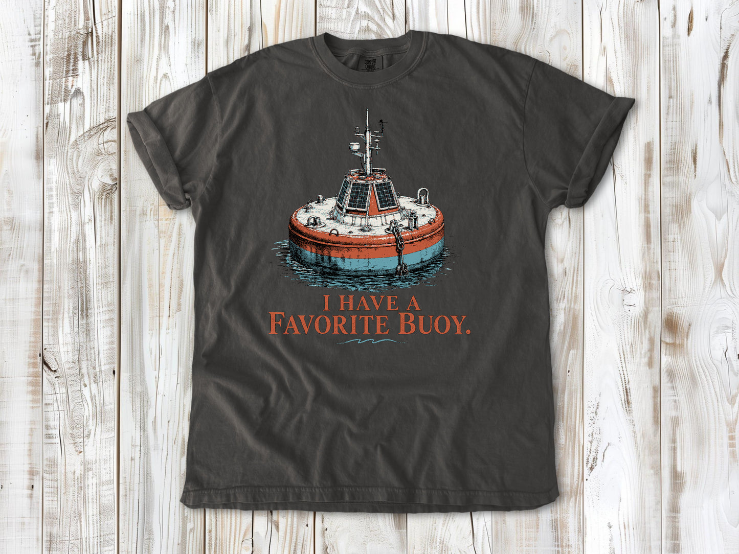 Ivory garment-dyed tee with I Have a Favorite Buoy surfing graphic.
