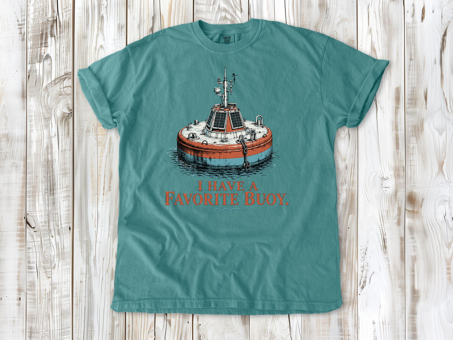 Mustard garment-dyed tee with I Have a Favorite Buoy surfing graphic.