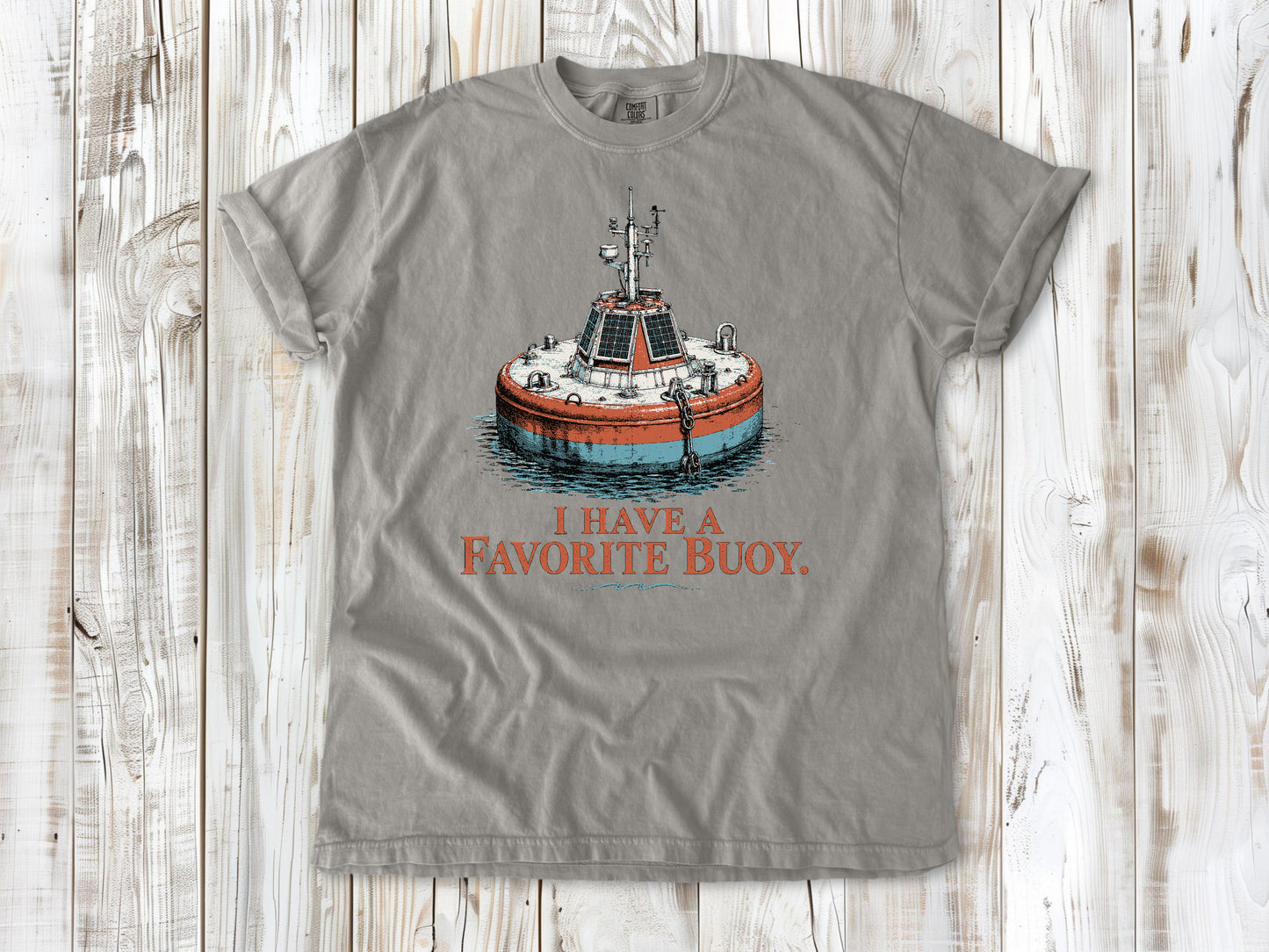 Khaki garment-dyed tee with I Have a Favorite Buoy surfing graphic.