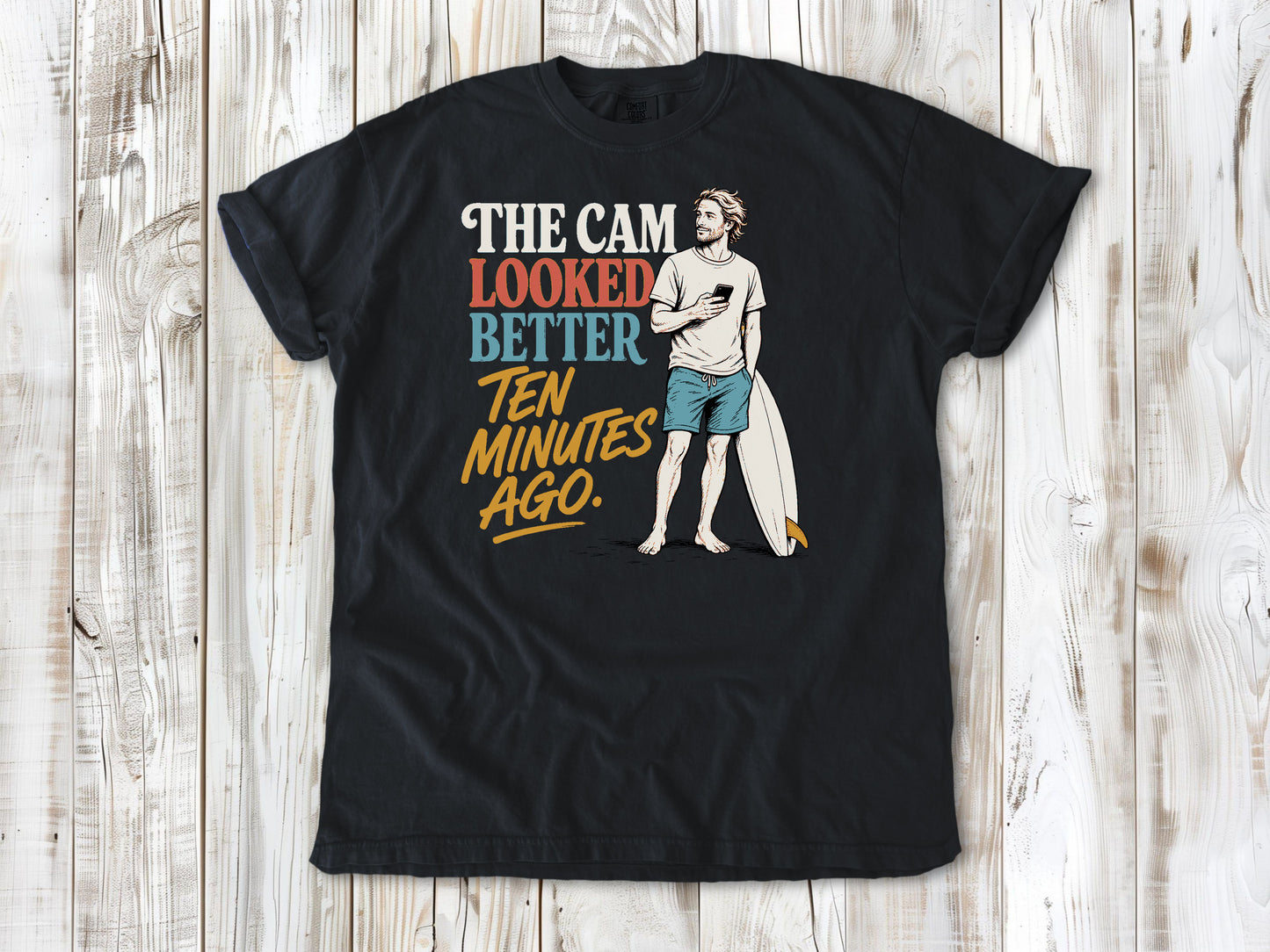 Washed Denim garment-dyed tee with The Cam Looked Better Ten Minutes Ago surfer graphic.