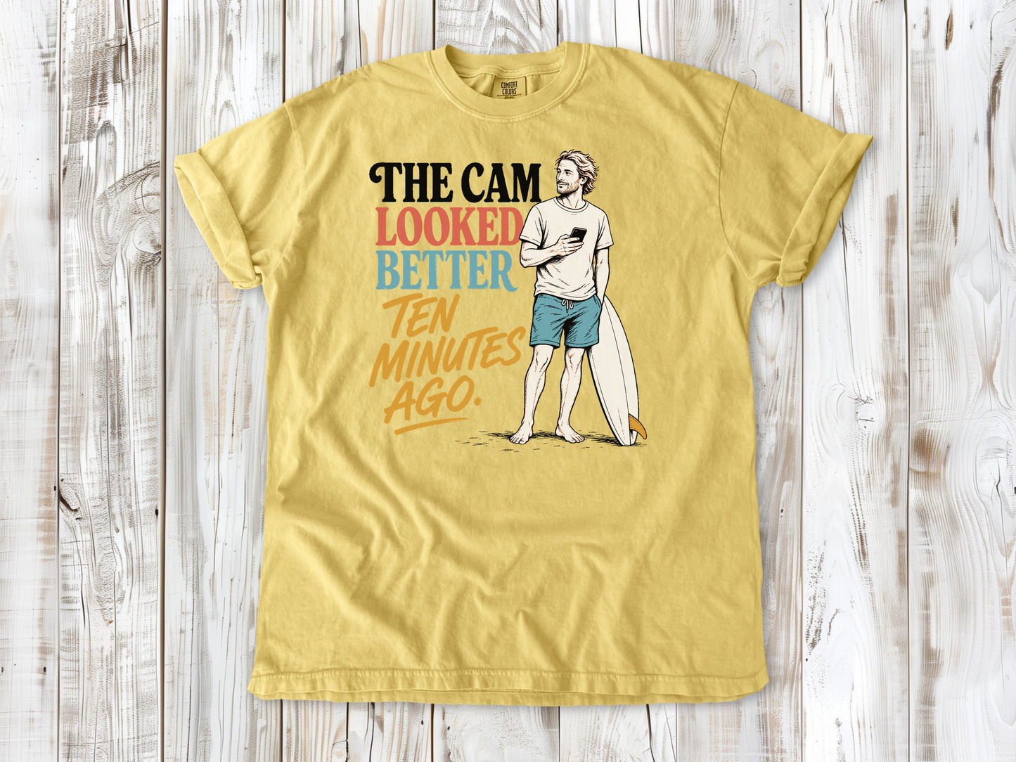 Grey garment-dyed tee with The Cam Looked Better Ten Minutes Ago surfer graphic.