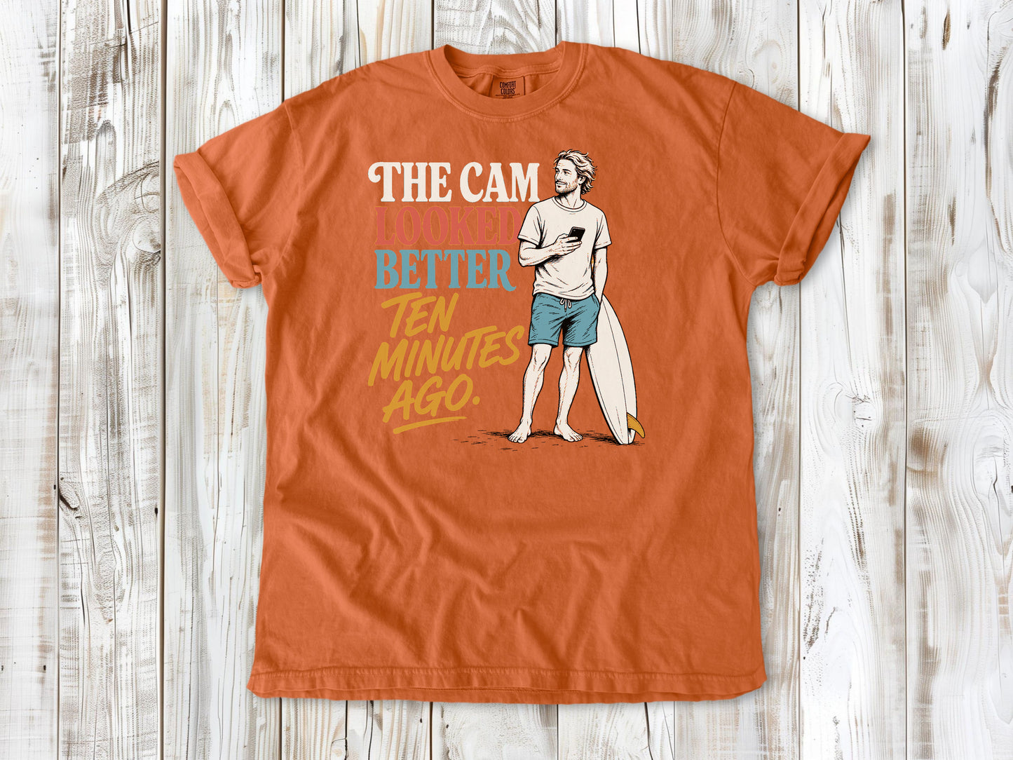 Seafoam garment-dyed tee with The Cam Looked Better Ten Minutes Ago surfer graphic.
