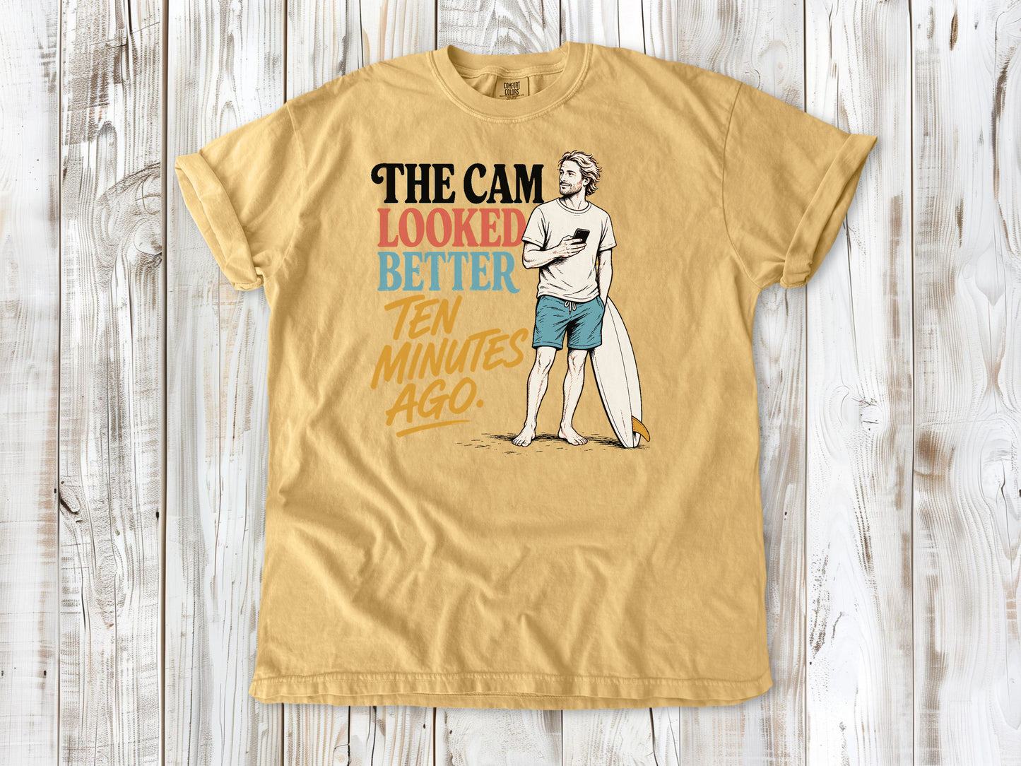 Burnt Orange garment-dyed tee with The Cam Looked Better Ten Minutes Ago surfer graphic.