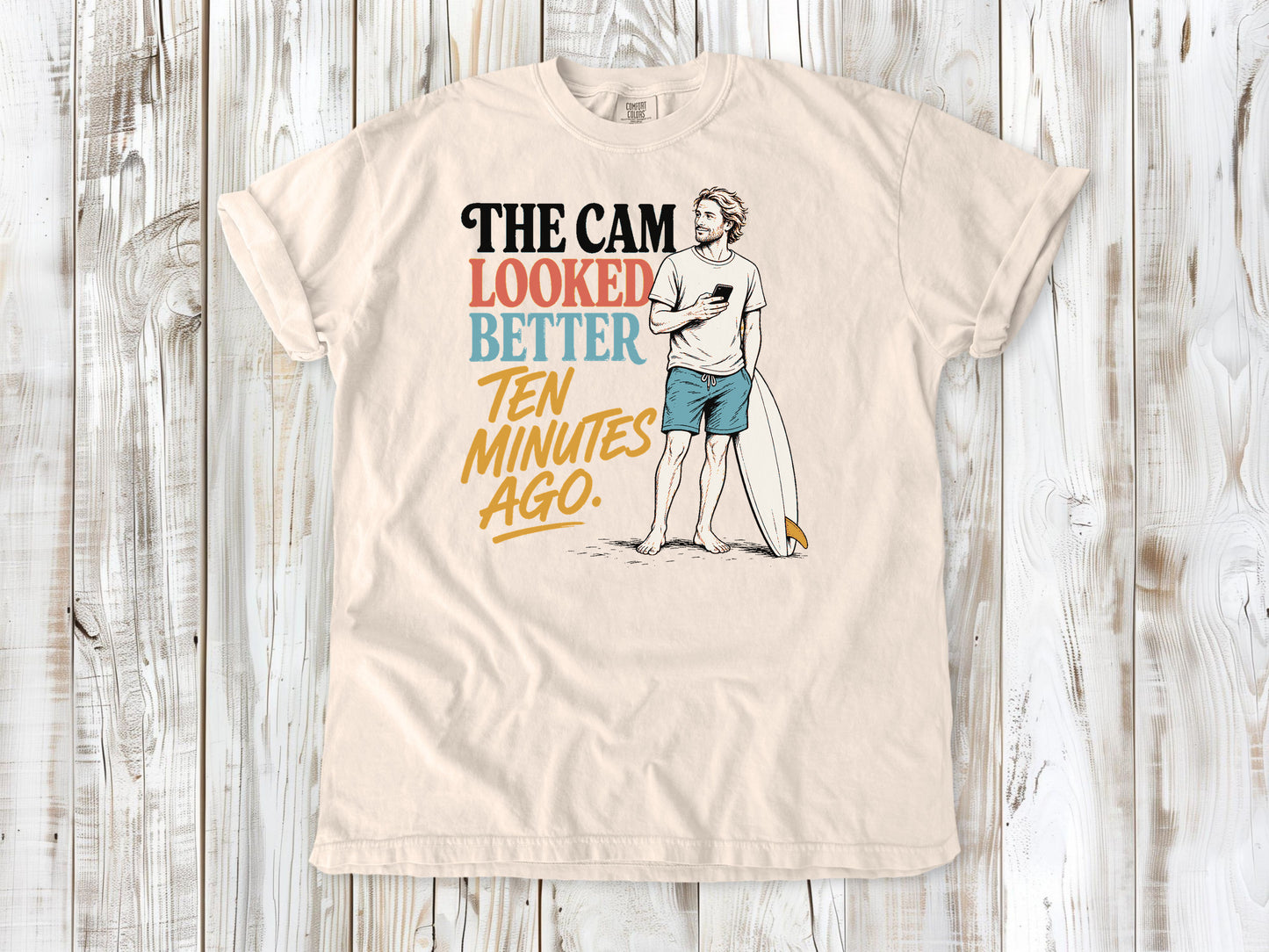 Butter garment-dyed tee with The Cam Looked Better Ten Minutes Ago surfer graphic.