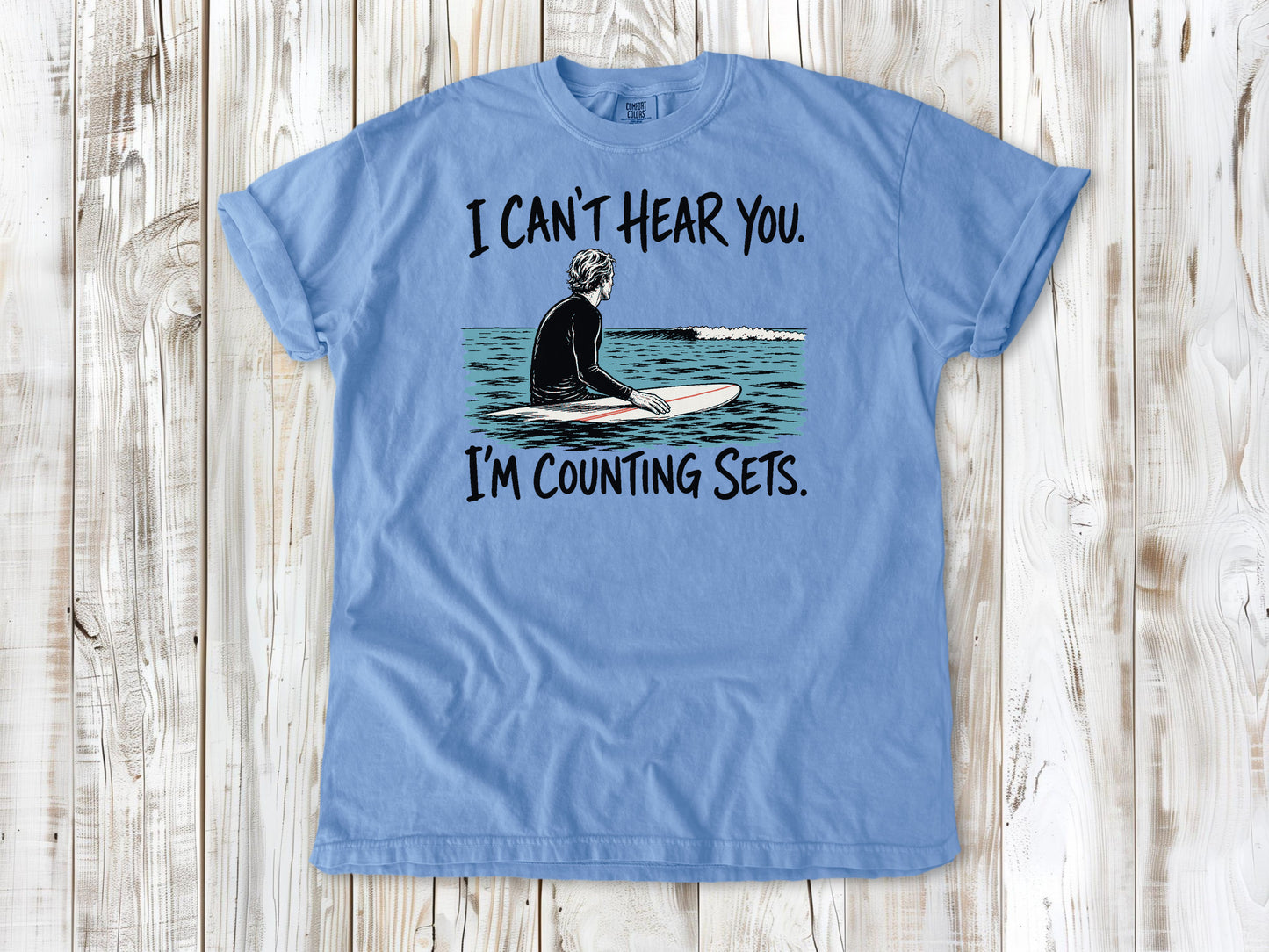Pepper garment-dyed tee with I Can't Hear You I'm Counting Sets surfer graphic.