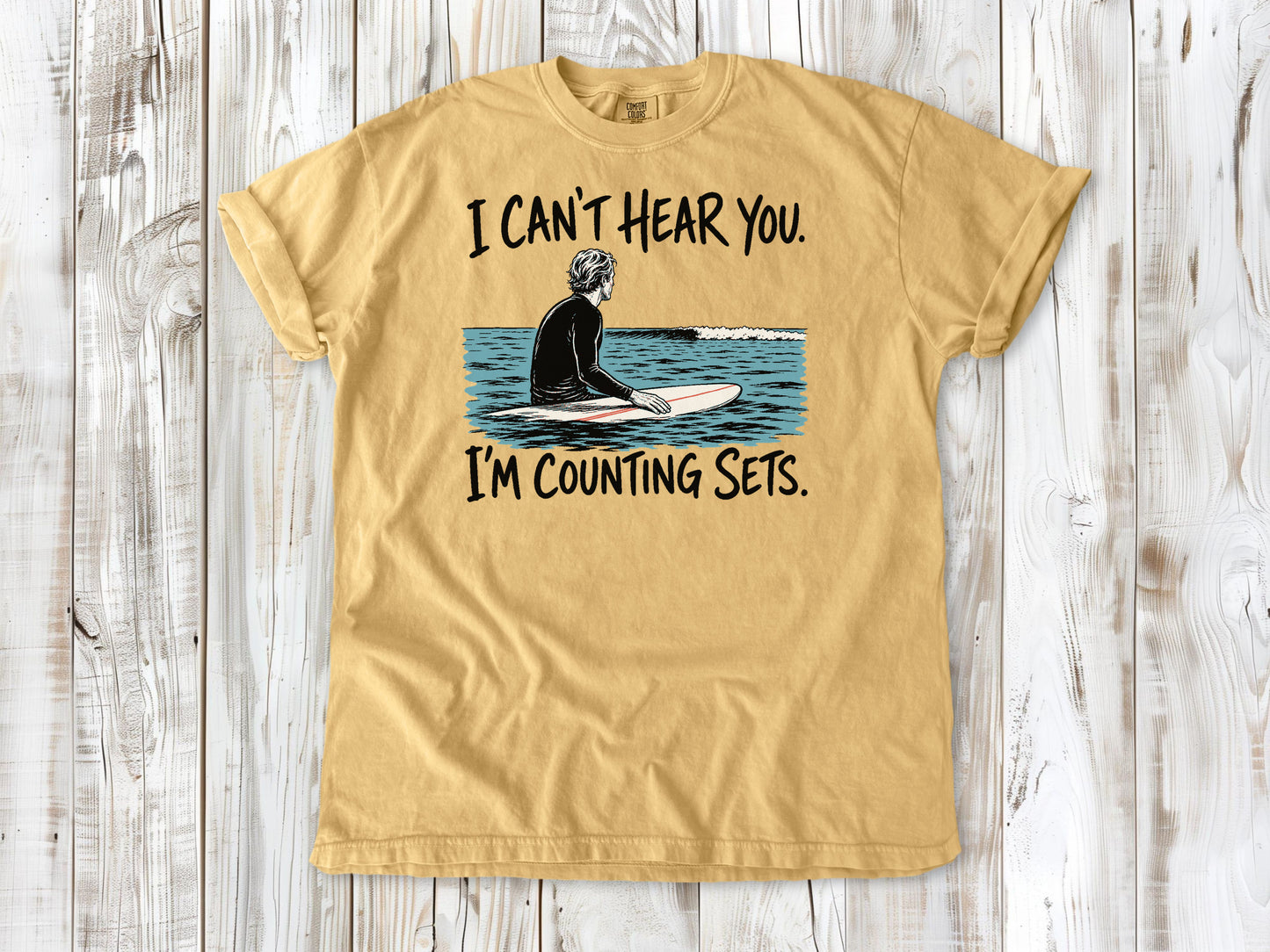 Burnt Orange garment-dyed tee with I Can't Hear You I'm Counting Sets surfer graphic.