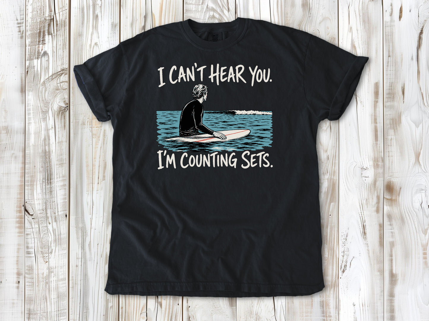 Washed Denim garment-dyed tee with I Can't Hear You I'm Counting Sets surfer graphic.