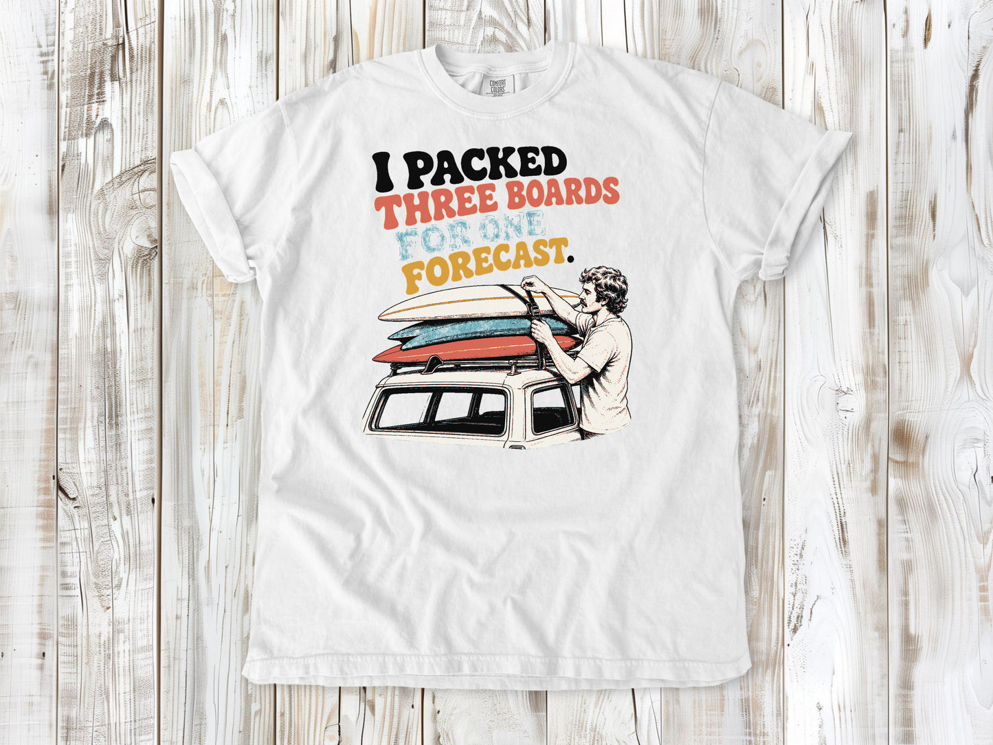 White garment-dyed tee with I Packed Three Boards for One Forecast surfboard graphic.