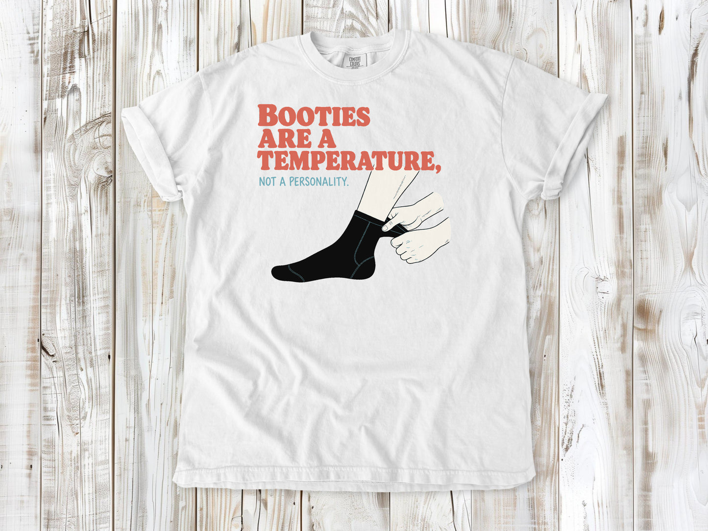 White garment-dyed tee with Booties Are a Temperature Not a Personality cold water surfing graphic.