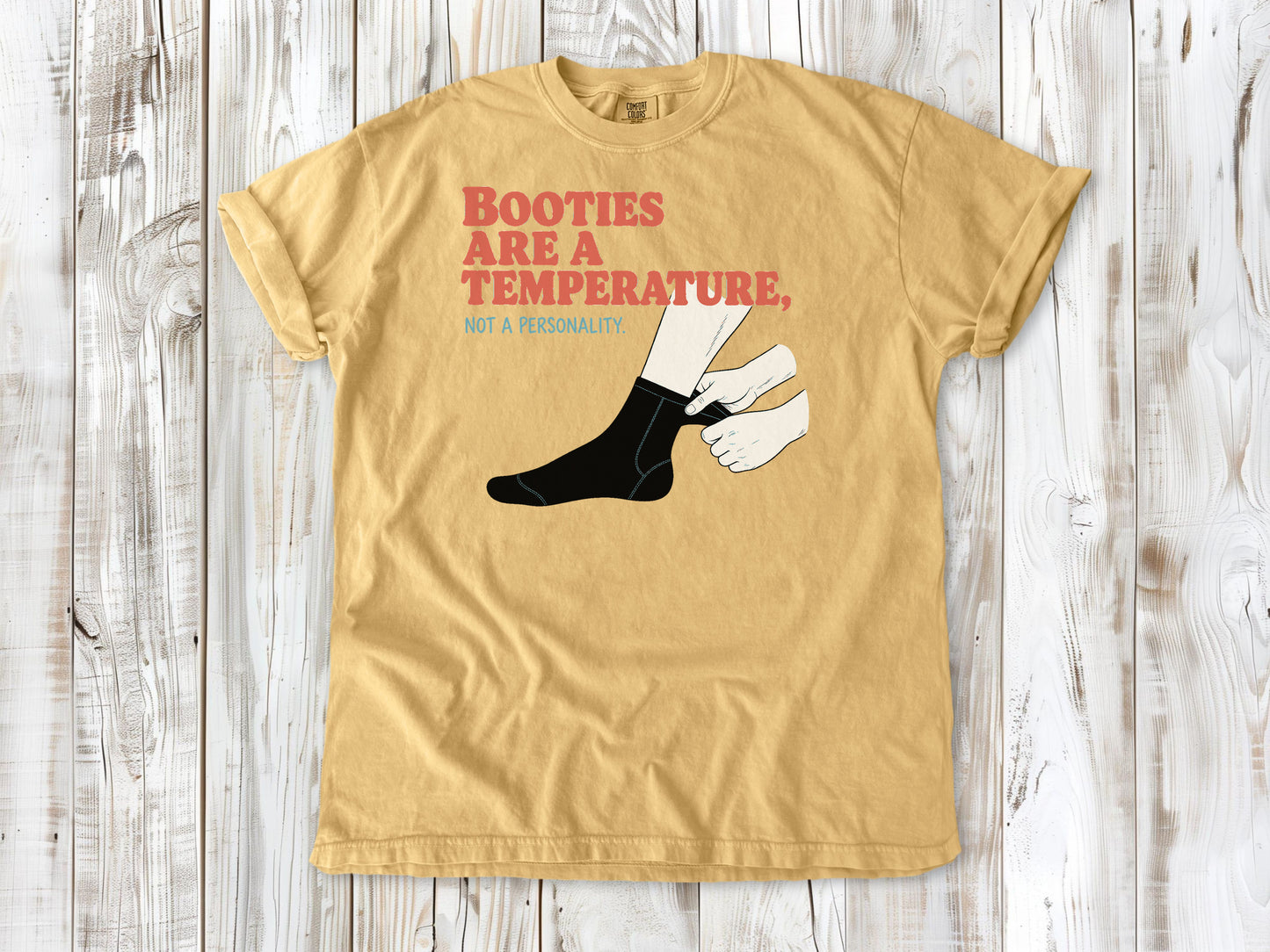 Burnt Orange garment-dyed tee with Booties Are a Temperature Not a Personality cold water surfing graphic.