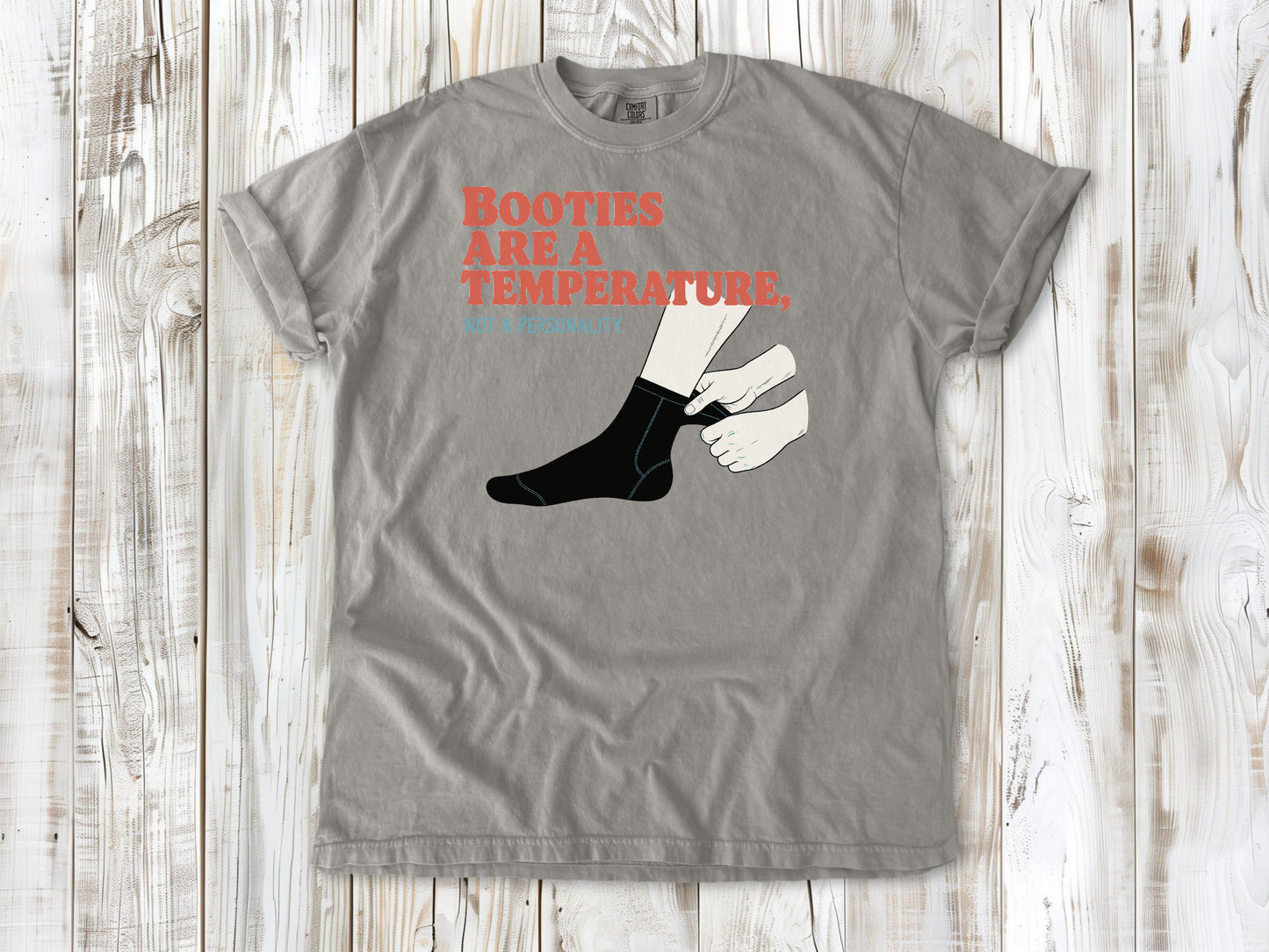 Khaki garment-dyed tee with Booties Are a Temperature Not a Personality cold water surfing graphic.
