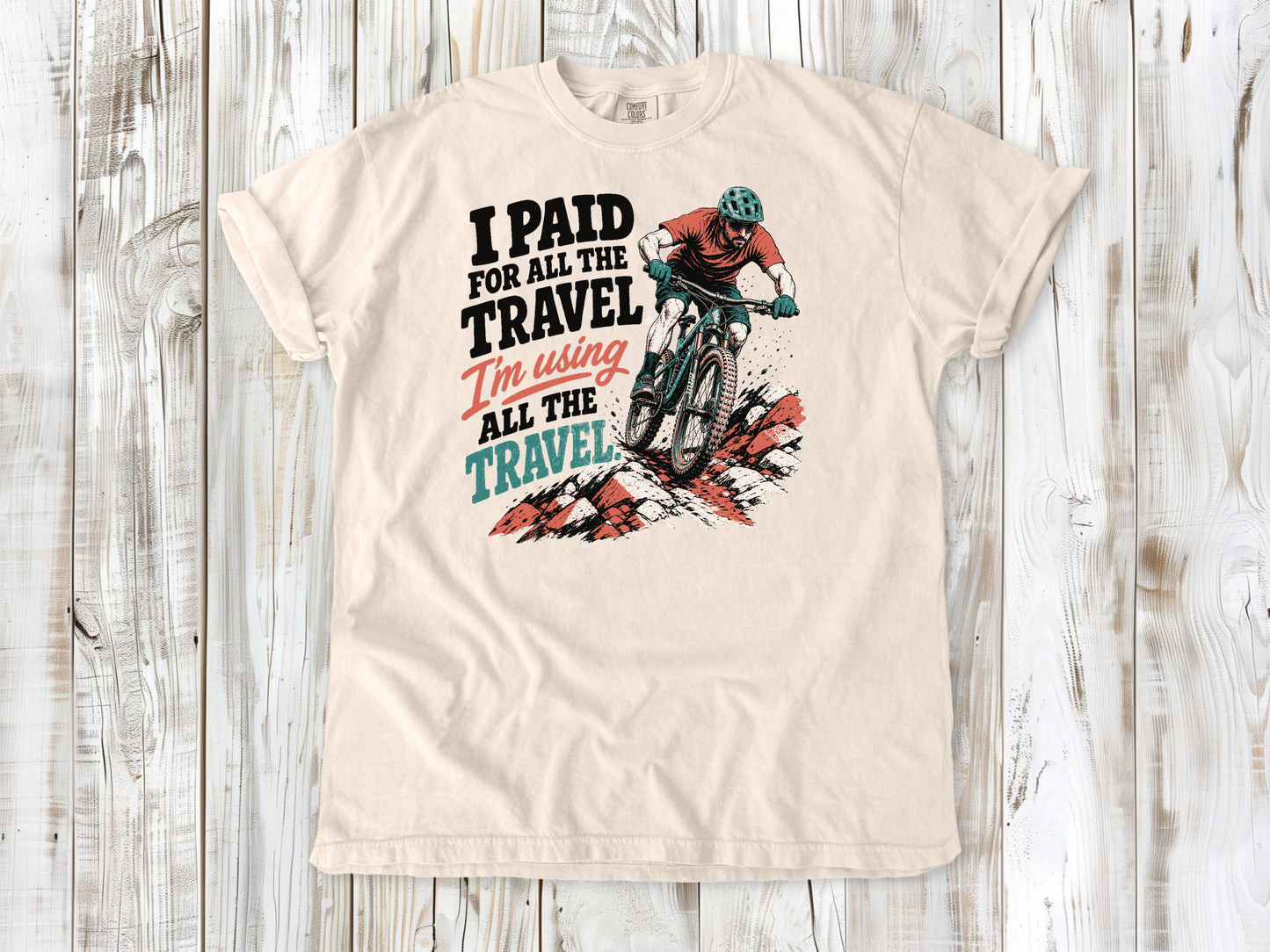 Butter garment-dyed tee with I Paid for All the Travel mountain bike graphic.