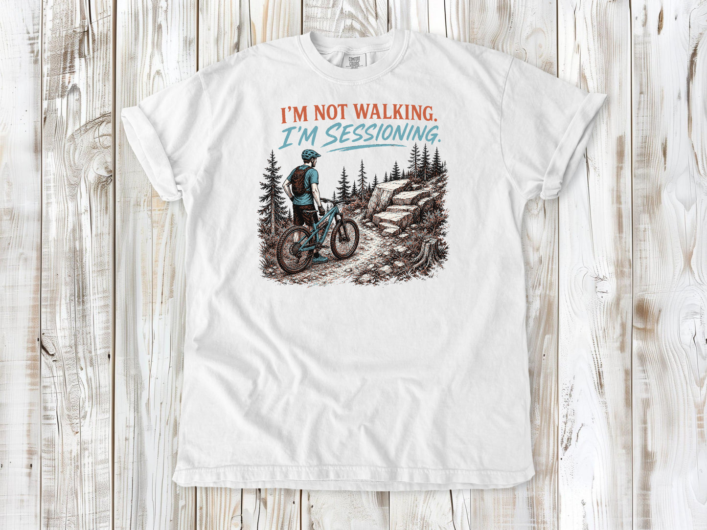 White garment-dyed tee with I'm Not Walking I'm Sessioning mountain biking graphic.