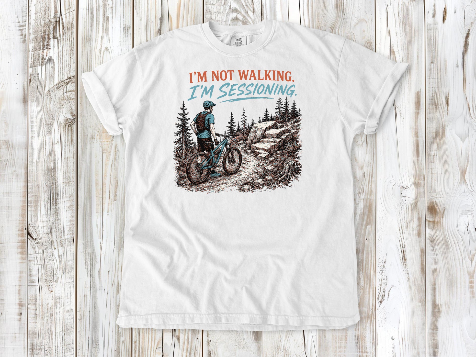 White garment-dyed tee with I'm Not Walking I'm Sessioning mountain biking graphic.