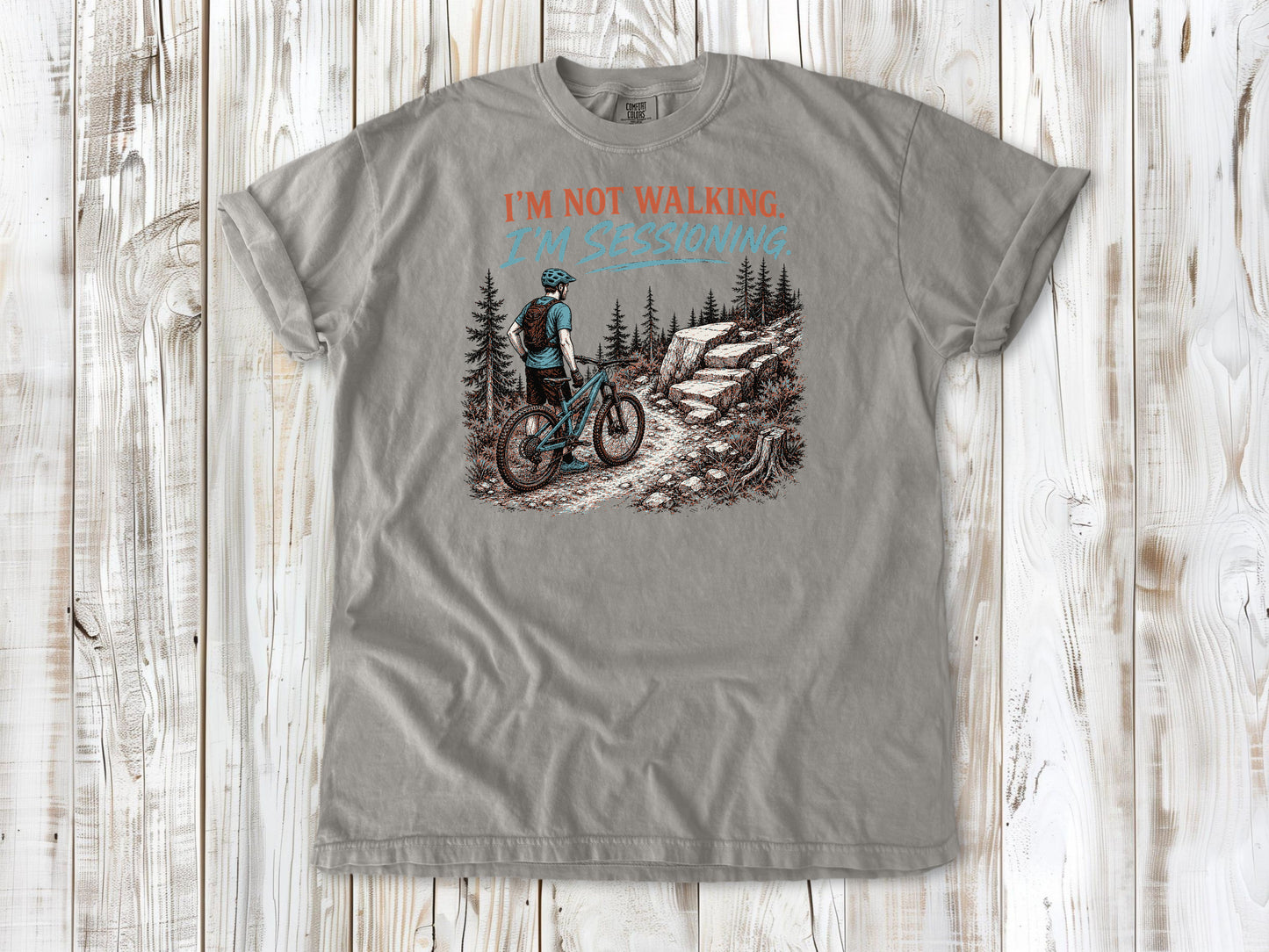 Khaki garment-dyed tee with I'm Not Walking I'm Sessioning mountain biking graphic.