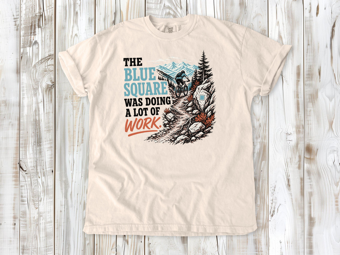 Butter garment-dyed tee with The Blue Square Was Doing a Lot of Work mountain bike trail graphic.