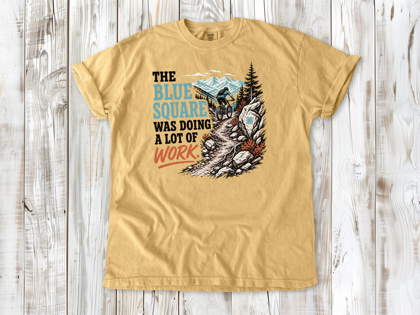 Burnt Orange garment-dyed tee with The Blue Square Was Doing a Lot of Work mountain bike trail graphic.