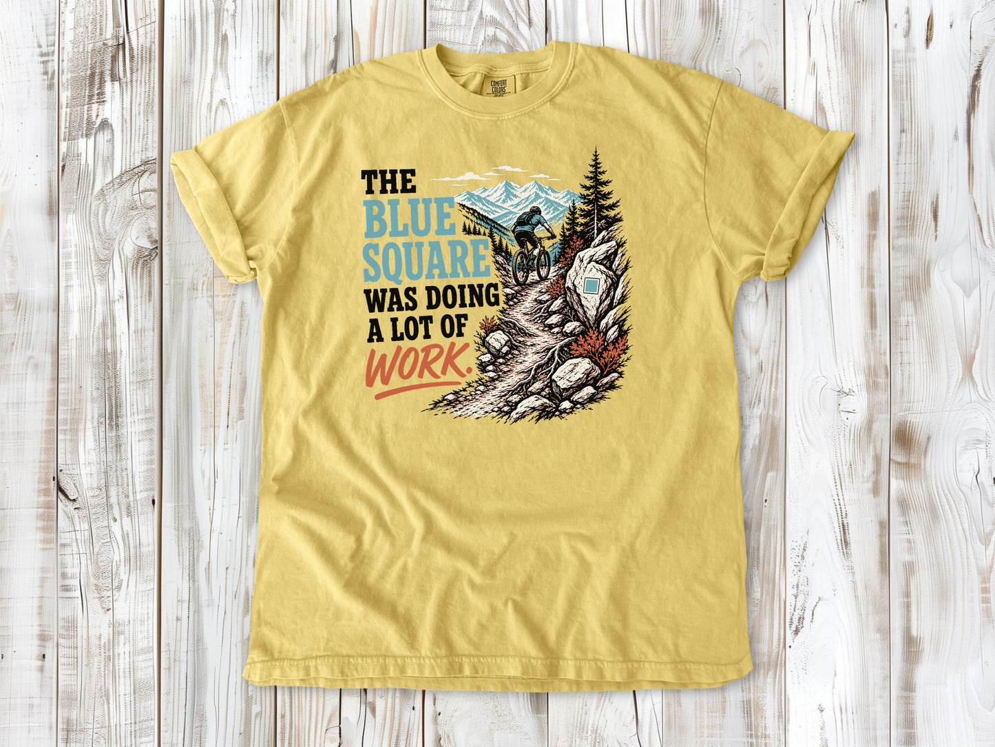 Grey garment-dyed tee with The Blue Square Was Doing a Lot of Work mountain bike trail graphic.