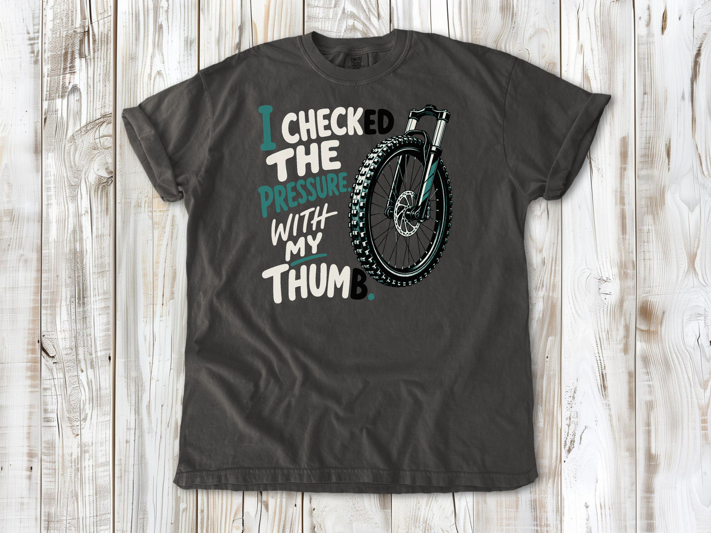Ivory garment-dyed tee with I Checked the Pressure With My Thumb mountain bike tire graphic.