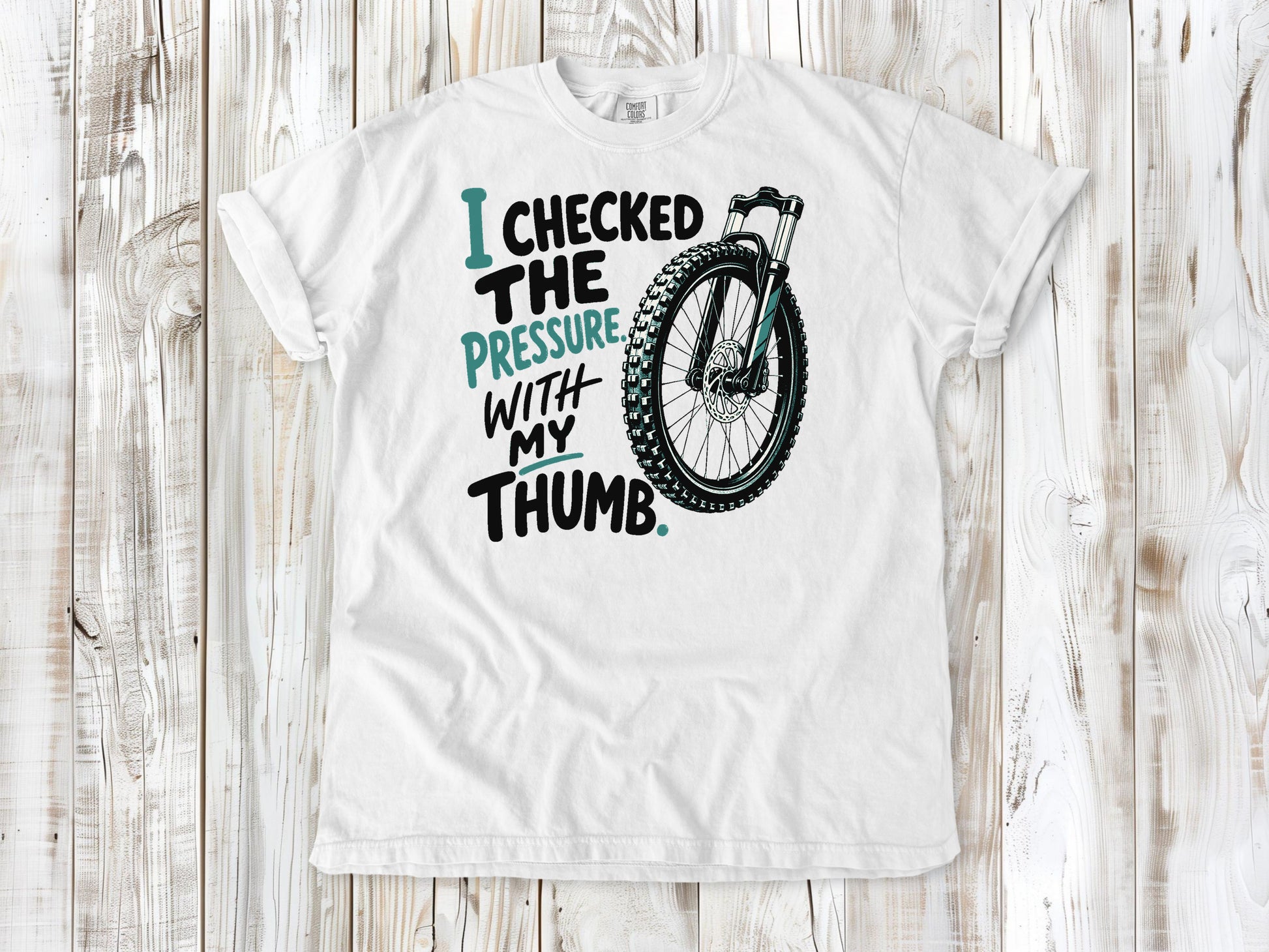 White garment-dyed tee with I Checked the Pressure With My Thumb mountain bike tire graphic.