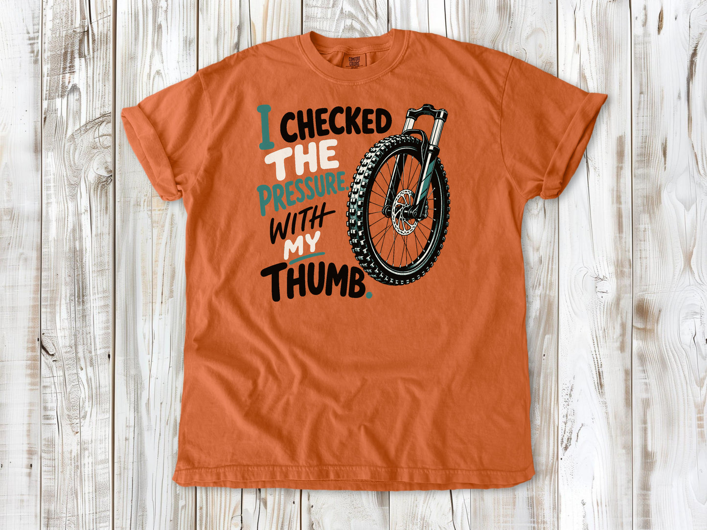 Seafoam garment-dyed tee with I Checked the Pressure With My Thumb mountain bike tire graphic.