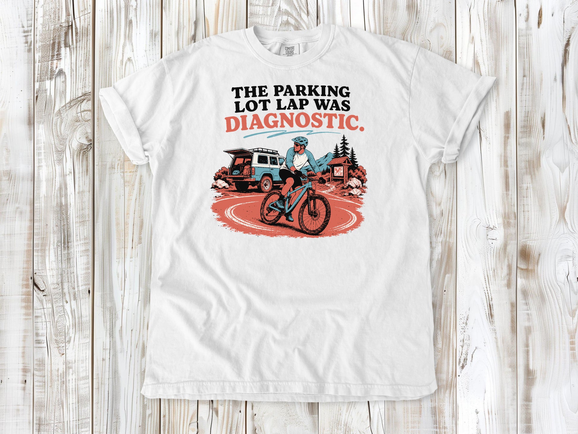 White garment-dyed tee with The Parking Lot Lap Was Diagnostic mountain biking graphic.